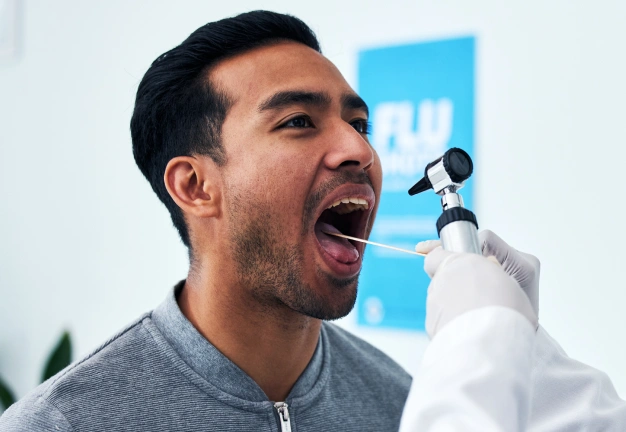 Man receiving dental examination with mirror tool in modern dental office setting